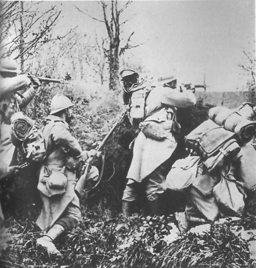 Photo taken during an actual attack. Soldiers had to constantly wear their knapsacks into the attack as the war of movement returned.
