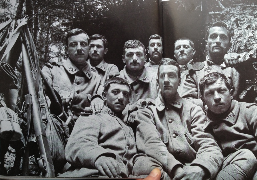 Sitting in front of their shelter. Photo taken by Frantz Adam, April 1915. Note the non-regulation buttons and the mix of greatcoats.