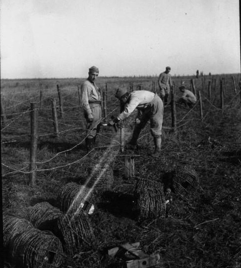 Soldiers setting up barbed-wire entanglements for a support position behind the front lines.