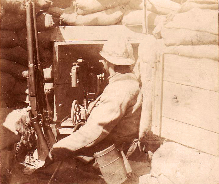 A soldier sits beside a Saint Etienne machine-gun.