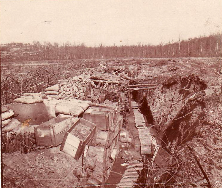 Old ammo crates have been used as revetment in this trench that also sports an armored observation turret. 