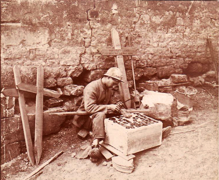 A soldier stencils in the names of the dead