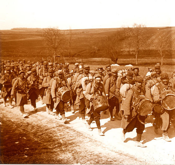 A regimental band marches at the head of a column, 1915.