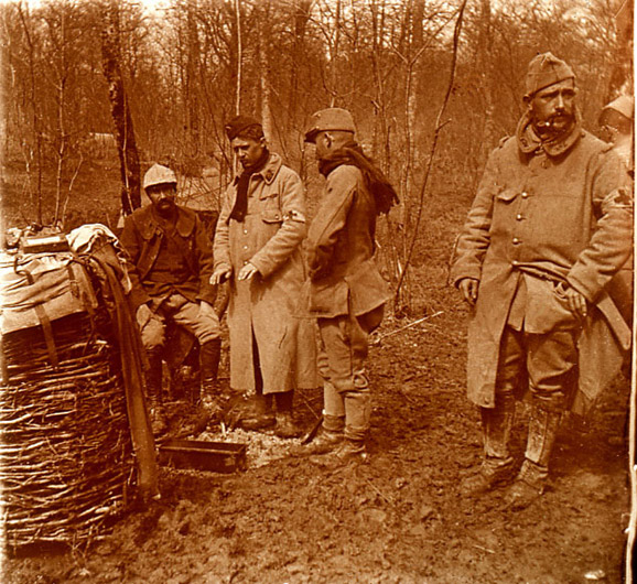 Medics warm themselves around a small fire.