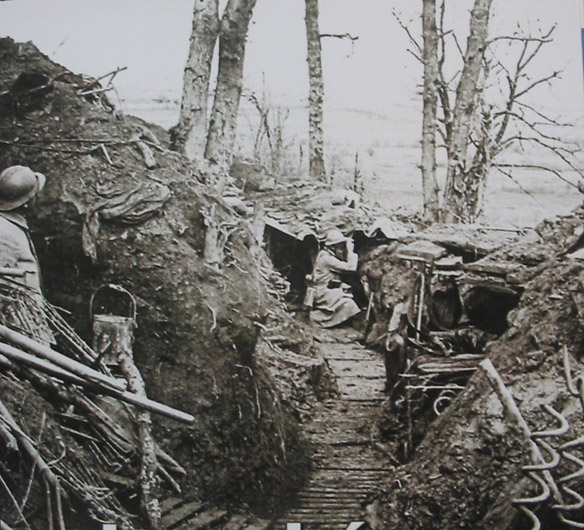 A soldier watches the enemy lines from the slopes of Les Éparges.