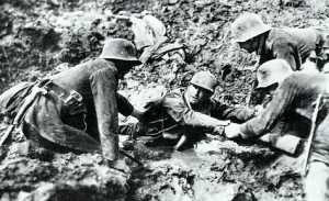German soldiers rescue a fellow-sufferer from drowning in deep mud.