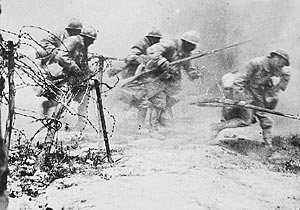 Soldiers charge over the top as shells land around them, Verdun.