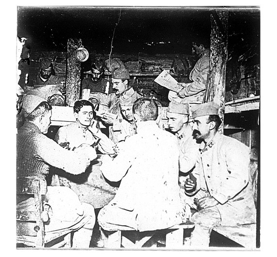 Soldiers playing a hand of Manille in a bunker.