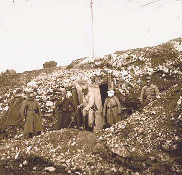 Soldiers don gas masks, Somme, 1915.