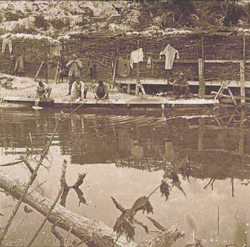 Several men wash up at their bath in Tahure.