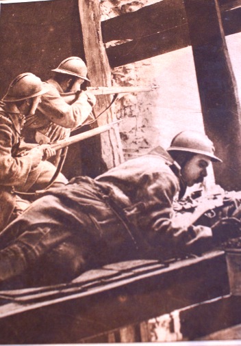 Snipers take up position high up in a ruined building.