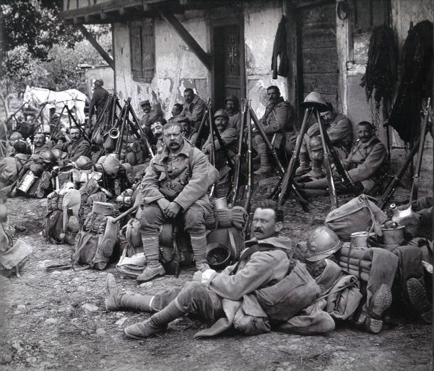 A weary group of older reservists or territorials takes a brief rest while on the march. (1916)