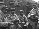 Soldiers sit down for a meal in the trench.