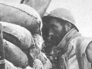 A look-out observes the enemy line via an armored trench shield.