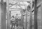 A well-constructed trench revetted with planks. Note the grenade blocks protruding above the trench. 