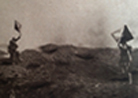 Photo taken during the assault on Dompierre (Somme) 1 July 1916 and showing two signal men using semaphores to signal to artillery observers.