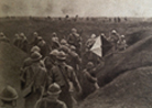 Photo taken during the assault on Dompierre (Somme) 1 July 1916. The second wave waits in a trench with the first waves visible in the distance. The man on the right holds a semaphore and additional signal men can be seen in the distance marking the progr