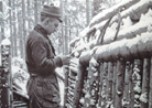 A soldier reads a letter, in a strongly revetted support trench in the mountainous Vosges region. Photo taken by Frantz Adam, 1915.