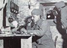 A telephonist and optics signaller in a command post at La Forain. Photo taken by Loys Roux, May 1916.