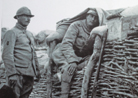 A soldier manning an observation post camouflaged by using a simple tent-canvas. Photo taken by Frantz Adam, July 1917.