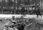 A group of American stretcher-bearers pass by a French MS emplacement in 1918.