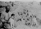 Soldiers proudly posing beside a large number of the rats killed by their dogs.