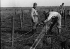 Soldiers setting up barbed-wire entanglements for a support position behind the front lines.