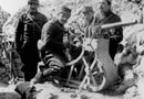 A gun crew stands by their revolver-canon on the summit of Vauquois, early 1915.