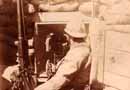 A soldier sits beside a Saint Etienne machine-gun.