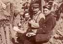 Note the rubberized kepi on the man seated at right. Ca. late 1914 / early 1915.