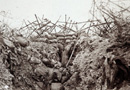 A bramble of wire-entanglements protect this shabby trench.