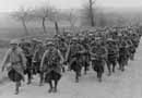 A column of French infantry on the march with the band and color guard in the lead, July 1918.