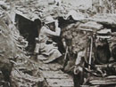 A soldier watches the enemy lines from the slopes of Les Éparges.