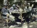 Soldiers relax over some food and letters, 1915.