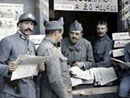 Soldiers gather around to pick up a copy of the latest paper, 1915.