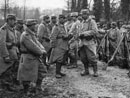 A column makes a brief halt during a march, 1915.