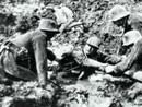 German soldiers rescue a fellow-sufferer from drowning in deep mud.