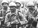 Soldiers coming out of Verdun, 1916. Note the soldiers carrying a German stick grenade and canteen.