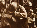 A soldier sleeps during a halt on the march.