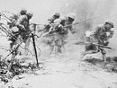 Soldiers charge over the top as shells land around them, Verdun.