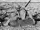 A soldier takes a close look at an unexploded heavy shell in Bois d'Avaucourt, Verdun.