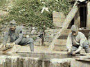 Soldiers cleaning their plates outside a bunker in the rear lines.