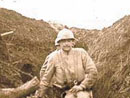 A soldier carries a drum through the muddy communication trenches at Les Éparges, 1915.