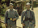 A group of territorials stand guard at the entrance to a barracks camp.