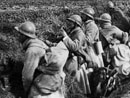 A squad occupies their freshly dug fox-holes along a roadside, Somme, 1918.