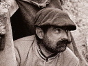 A man emerges from the entrance to a listening post, Nieuport 1915.