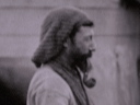 A cook mounted on his field kitchen prepares a meal.