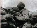 A Chauchat gunner has improvised camouflage for his helmet using a sandbag.