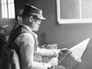 A blinded soldier works on a piece of crochet.