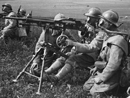 Machine-gunners on training operations wearing Tissot gas masks. (1916)